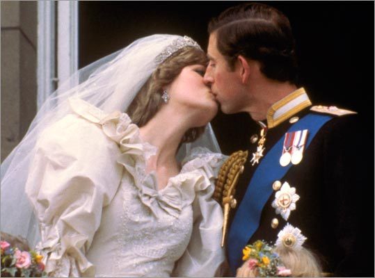 Britain's Prince Charles kisses his bride, Princess Diana