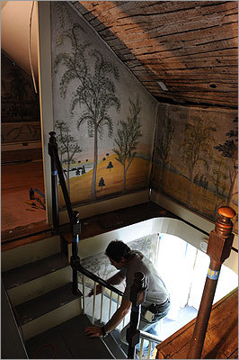 Carpenter Jim Derby of Waldoboro, Maine works to cut out a section of mural in the Haines's home.