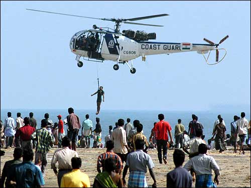 An Indian Coast Guard helicopter airlifts a fisherman from Marina beach.