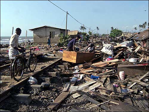 A man inspects what is left of his home.