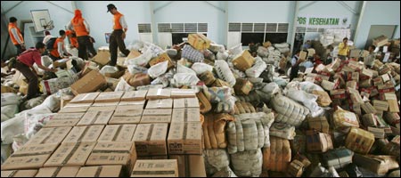 Officials gathered logistical and medical supplies for tsunami victims in Aceh Province at the Polonia military airbase yesterday in Medan, Indonesia. Inefficiency and lack of transportation contributed to the slow distribution of supplies in the country. (Getty Images)