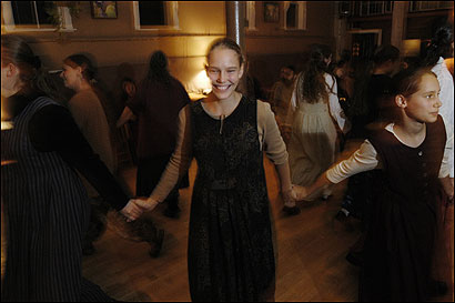 Twelve Tribes members, including Lavah Howley (center), dance and dine together on Friday nights in Plymouth.