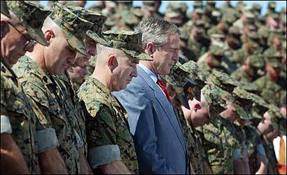 President Bush joins marines in prayer at Camp Lejeune, N.C., on April 3, 2003. Accordiing to a Pew Charitable Trusts poll that month, 87 percent of white American evangelicals supported the president's decision to invade Iraq.