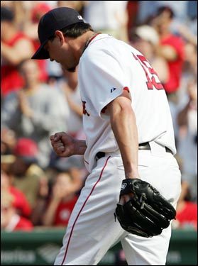 Josh Beckett pumps his fist after getting the final out of the eighth inning. Beckett gave up seven hits and two earned runs while striking out eight in eight innings of work, but left with the Sox trailing the Blue Jays, 2-1.