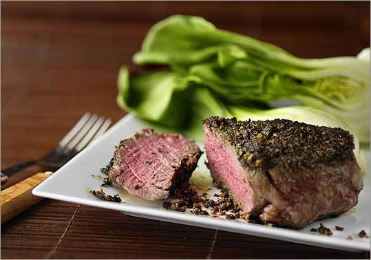 Crumbled green tea leaves and minced lemon grass are rubbed over a tender cut of beef before the meat is seared on a stove top.