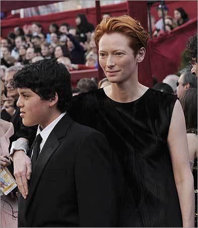 British actress Tilda Swinton, right, nominated for an Oscar for best actress in a supporting role for her work in 'Michael Clayton,' and a guest arrive for the 80th Academy Awards