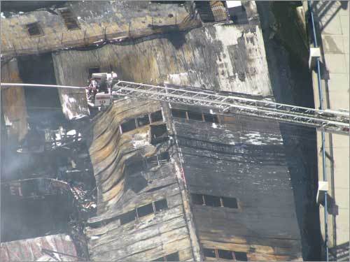 Firefighters worked to control the seven-alarm fire that destroyed the landmark seafood business.