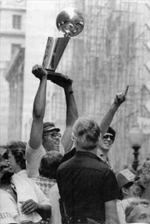 M.L. Carr held up the NBA championship trophy and Kevin McHale gave the number one sign during the 'Celtics Pride Day' parade on June 14, 1984. The parade to celebrate the Celtics' 15th NBA championship win began at Park Square and ended at Boston City Hall. An estimated 250,000 people came to watch the parade.