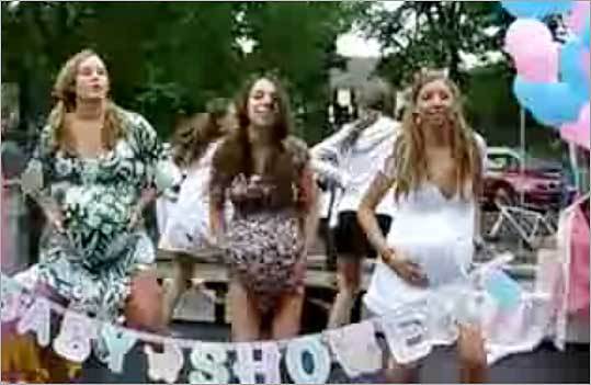 This screen shot from YouTube.com shows dancing girls on a float pretending to be pregnant during Beverly Farms' Fourth of July Horribles parade.