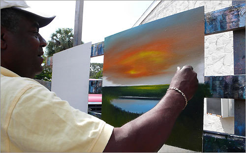 Al Black paints on a canvas at his home in Fort Pierce's Lincoln Park neighborhood. The scene before him is the stucco side of his neighbor's house.