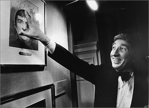 A straight-A student in high school, Updike earned a scholarship to Harvard University, where he continued to excel. He graduated summa cum laude in English and was president of Harvard’s student humor magazine, the Lampoon. Updike is seen here in 1980 playfully covering a copy of a 1968 Time Magazine cover of him at the Harvard Book Club.