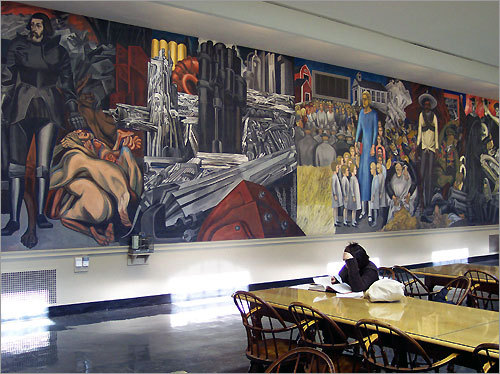 Images from Jose Clemente Orozco's 'The Epic of American Civilization' tower over students in the reading room at Dartmouth College's Baker-Berry Library in Hanover, N.H.