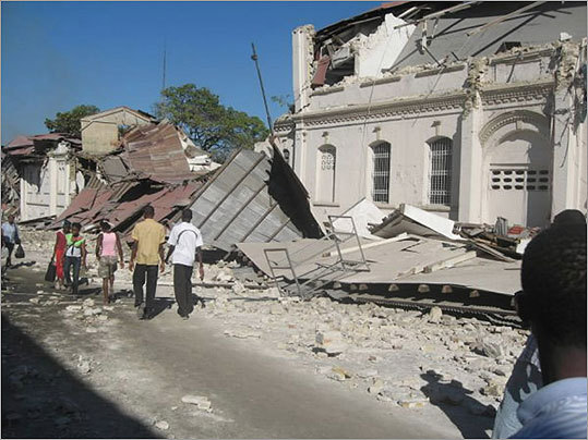 Haitians passed several building destroyed in the earthquake.