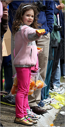Sydney Holzman, 6, offered a health alternative--oranges, to runners at Heartbreak Hill.