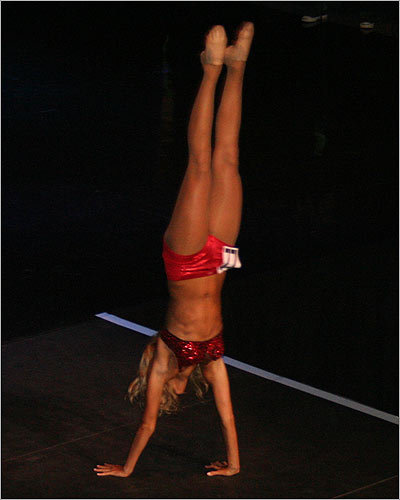 Hoping to regain her spot on the team, Ashley M. dazzled the judges with a handstand and red sequins.