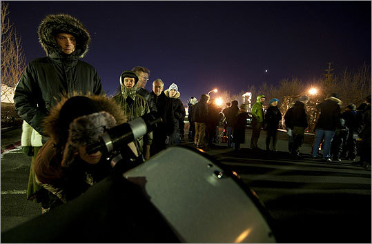 In a parking lot in Reykjavik, Iceland, a crowd of about 30 people braved the bitter cold to observe the eclipse.