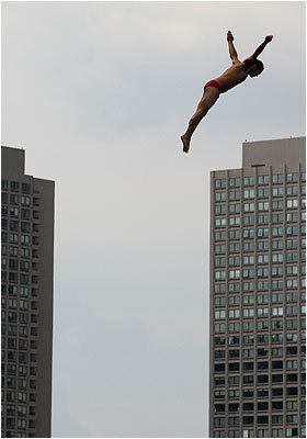 World-class cliff divers soar eight stories above harbor