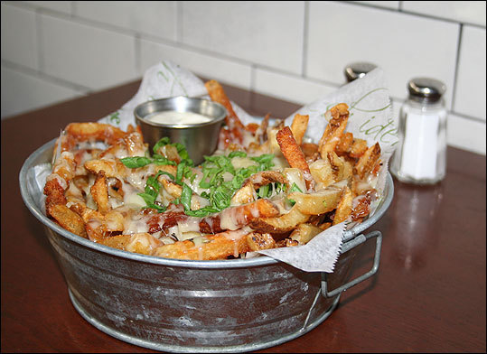 Truffle fries Kingston station The fries: House cut fries, gruyere cheese, scallions, truffle oil. My take: Leave an empty stomach before ordering these fries -- they're heavy, gooey, and hard to stop eating. 'Almost every table gets one,' said waiter Bob Lupo. 'It's actually a little rare when people don't.' Read the Globe review of Kingston Station $10, $14 Kingston Station 25 Kingston St., Boston, 617-482-6282