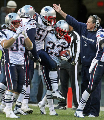Patriots head coach Bill Belichick (right) gave linebacker Jerod Mayo (51) a pat on the head for a job well done as he was carried off the field by teammates - including Nate Jones, (23) who is also carrying the ball for him - after he appeared to be limping after coming up with the ball in the end zone on Washington's last play from scrimmage in the game.