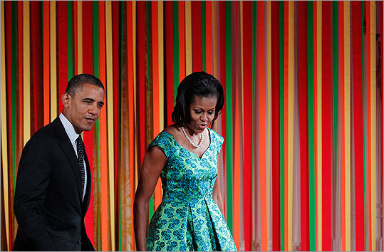 Mrs. Obama wore a bold blue and green printed dress as she hosted the first ever 'Kids State Dinner' in the East Room of the White House on Aug. 20. The event included 54 children from across the United States who won a nationwide recipe competition. The luncheon supported the Let's Move campaign and featured healthy recipes and a performance by Nickolodeon's Big Time Rush.