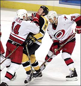 Steve Halko checks P.J. Axelsson