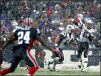 Patriots quarterback Tom Brady (12) fired a pass through the snow as he led New England to a 35-7 victory over the Buffalo Bills.  (Globe Staff Photo / Jim Davis)