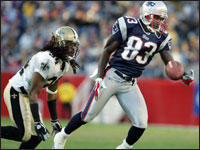 Patriots wide receiver Deion Branch (right) made a great one-handed catch off a pass from Tom Brady in front of Saints cornerback Mike McKenzie (left). A frustrated McKenzie was penalized for a hit on Branch after he pushed him out of bounds following the catch.  (Globe Staff Photo/Jim Davis)