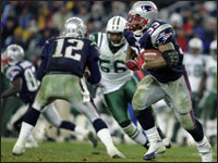 Patriots running back Kevin Faulk (33) gained some fourth quarter yardage with the help from an unusual blocker: quarterback Tom Brady (12). (Globe Staff Photo / Jim Davis)