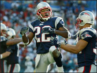 Patriots cornerback Assante Samuel (22) celebrated with running back Michael Cloud (34), as Richard Seymour (backround far left) and Tom Brady (backround second from left) embraced. Samuel broke up the final pass from the Dolphins quarterback Gus Frerotte in the endzone, to preserve New England's victory over Miami. (Globe Staff Photo/Jim Davis) 