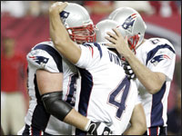Patriots Dan Koppen (67) and Josh Miller (8) congratulated teammate Adam Vinatieri (4) after Vinatieri kicked a game-winning field goal during the final minutes of the game against the Atlanta Falcons. The Patriots won 31 to 28 in Atlanta, GA. (Globe Staff Photo / John Bohn) 