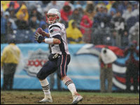 Tom Brady looking for an open reciever in the driving rain during third quarter action against the Tennessee Titans.