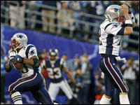Tom Brady (12) was airborne as he pumped his fist next to Chargers linebacker Shawne Merriman (56) following the first New England tocuhdown of the game.