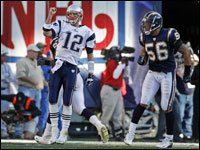 Tom Brady (12) was airborne as he pumped his fist next to Chargers linebacker Shawne Merriman (56) following the first New England tocuhdown of the game.