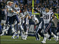 Patriots (left to right) Mike Wright (99) and Matt Cassel (16) leap high as they celebrate after the Chargers Nate Kaeding missed a potential game tying field goal that sealed New England's victory. Corey Dillon (28) also joins the fun at far right.