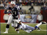 Patriots wide reciever Chad jackson has the pass and some first quarter yardage before getting tackled by the Colts' Jason David.