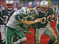 Patriots running back  Laurence Maroney is tackled by New York Jets kicker Mike Nugent and Erik Coleman on a 36-yard kick off return.
