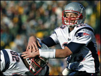 Patriots quarterback Tom Brady (right) celebrates with tight end Daniel Graham (left), one of four teammates he threw touchdown passes to in the game.