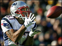 Patriots wide reciever Reche Caldwell keeps his eyes on the ball as he hauls in a 54-yard touchdown pass from quarterback Tom Brady.