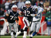 Tom Brady picks up five yards rushing with Detroit Lions defensive end Corey Smith in pursuit.