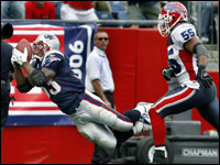 Kevin Faulk (left) sails through the air and hauls in a 17 yard third quarter touchdown pass from quarterback Tom Brady. 