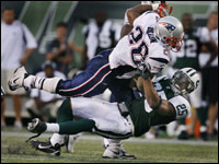 Patriots running back Corey Dillon put a vicious hit on New York safety Kerry Rhodes, running over him for a ten yard gain.