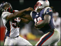 Broncos' #52 tries to stop Patriots' #39 Laurence Maroney in the third quarter