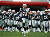 Patriots co-captain, linebacker Mike Vrabel (50) leads the defense onto the field for the season opener at Gillette Stadium.