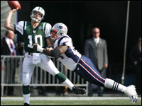 Patriots DL Ty Warren (right) sails through the air as he nails Jets quarterback Chad Pennington just as he is trying to release the ball, which fell incomplete.