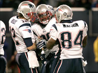 New England Patriots quarterback Tom Brady, at left, hugs running back Laurence Maroney after Maroney scored on the 2 point conversion that put the Patriots up 31-28 over the Giants in the 4th quarter.