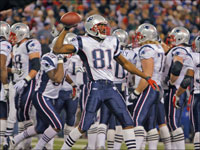 This one's a keeper. After Patriots wide reciever Randy Moss hauled in his second touchdown pass of the game to break Jerry Rice's single season record, and after New England then scored a two point conversion with the same ball, Moss retrieved the ball and tossed it to the sidelines for safekeeping as a memento.