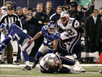 New England Patriots linebacker Mike Vrabel seals the victory (and the perfect regular season) for the Patriots after making the catch of a New York Giants onside kick late in the 4th quarter.