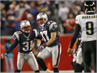 Brandon Meriweather celebrates with Rodney Harrison after Harrison made a interception in the fourth quarter against the Jacksonville Jaguars in the AFC Divisional Playoffs.