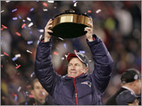 New England Patriots head coach Bill Belichick lifts up the Lamar Hunt trophy, awarded to the champion of the AFC.