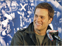 Quarterback Tom Brady took questions from a raised table, behind which was a montage of black and white photographs of past Super Bowl MVPs, including one over his shoulder of his boyhood hero, quarterback Joe Montana of the San Francisco 49ers.